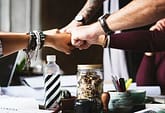 Profitable-Alignment-Dr-Catherine-Multiracial-Fist-bump Fist bumping-Multi-racial Men and Women
