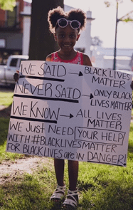 Little Girl holding a sign: We Said, "Black Lives Matter." We never said, "Only Black Lives Matter." We Know, "All Lives Matter." We just need your help with the #BlackLivesMatter because Black Lives are in Danger.