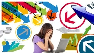 Profitable-Alignment-Dr-Catherine-Too-Much-Stress Woman at her desk with a laptop with her head in her hands